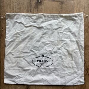 Prada cream /white color dust bag with logo .